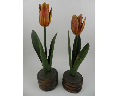 A pair of unusual carved treen studies of tulips, raised on naturalistic bases, reputedly made by Welsh minors from Pit Props