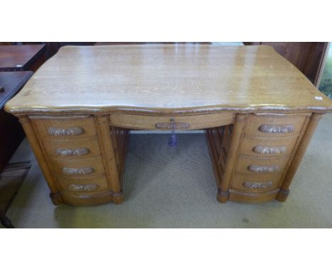 A good 20th century light oak kneehole desk with two slides and nine drawers and panelled sides and back - Height 83 cm x Wid