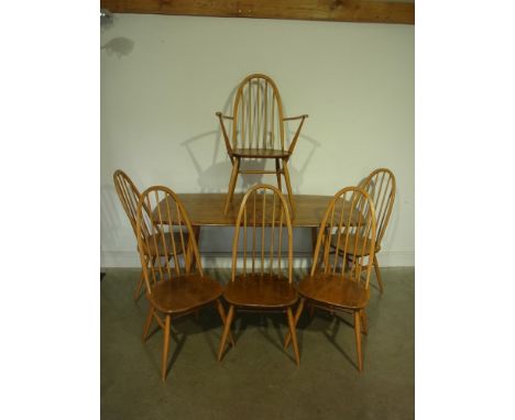 An Ercol light elm dining table with six chairs including one carver - 1.52 m x 76 cm