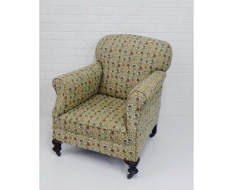 A floral upholstered armchair on mahogany feet and ceramic castors, 82 x 70cm 