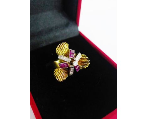 A vintage 14k gold dress ring, circa 1970's, with three textured gold panels in the style of Andrew Grima, centred by a claw 
