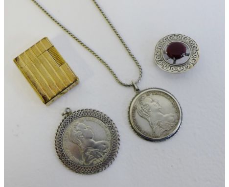 A mixed lot to include DuPont gold plated lighter, two Maria Theresia Thaler coin pendants and a silver brooch (4) 