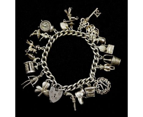 Silver charm bracelet with heart padlock clasp and eighteen silver charms including alarm clock, ballerina and mouseCondition