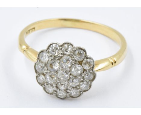 18ct Gold flower head ring set multiple old cut diamonds, size O, 2.7gChip to two diamonds. Mount worn.