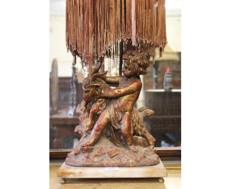 Red and gilt patinated spelter group of cherub and goat mounted on rectangular marble base with table lamp fitting, 84cm high