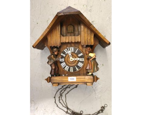 Swiss carved wooden cuckoo clock with a two train weight driven movement