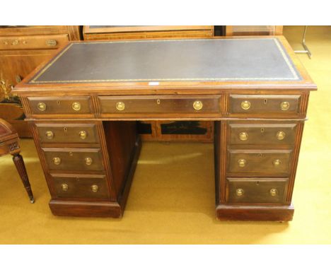 Edwardian mahogany twin pedestal desk, the leather inset top above nine drawers with brass ring handles and plinth bases, 122