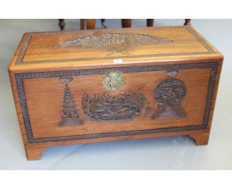 Mid 20th Century Eastern camphor wood trunk with hinged cover and carved decoration
