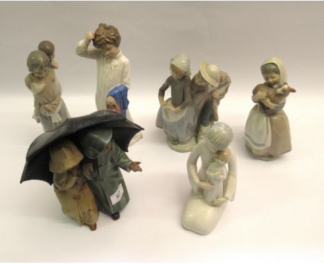 Group of five various Lladro, Nao, other similar figures and a matt glazed group of two children with an umbrellaLladro figur