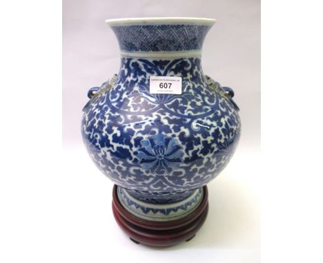 Chinese blue and white floral decorated squat baluster vase on a hardwood stand, signed with seal mark to base, 29cm highIn e