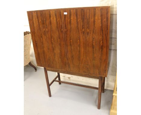 Good quality mid 20th Century exotic hardwood drinks cabinet on stand, the flush panelled doors enclosing a fitted interior w