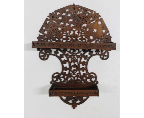 Mahogany fretwork two shelf wall bracket, decorated with playing cards, 45cm high