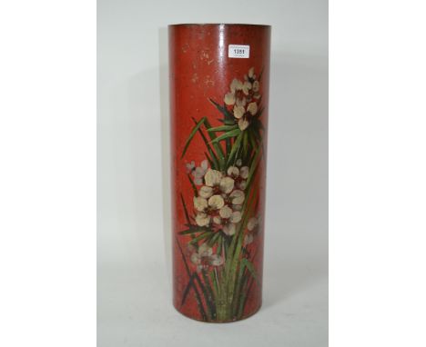 Toleware cylindrical stick stand with painted floral decoration on a red ground, 56.5cm high
