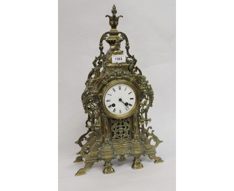 Ornate brass mantel clock, the circular enamel dial with Roman numerals with two train movement (minus bell)