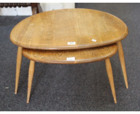 Two mid 20th Century Ercol elm pebble coffee tables, the largest 65 x 44cm