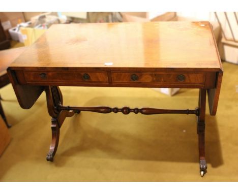 19th Century mahogany and yew wood crossbanded drop-leaf sofa table, with two drawers having circular brass handles and lyre 