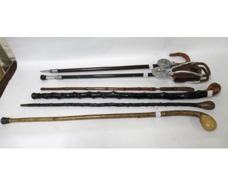 Two shooting sticks by Mills of Birmingham, together with three various walking canes and an antique sword stick