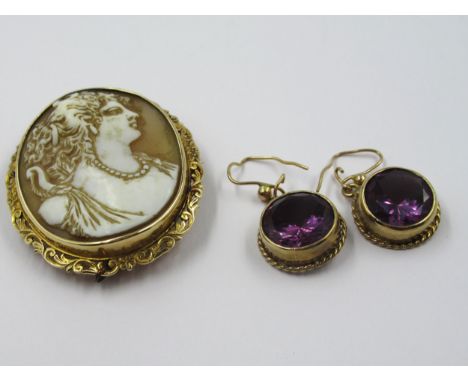 Oval carved shell portrait cameo brooch in a yellow metal mount, together with a pair of circular mauve stone drop earrings
