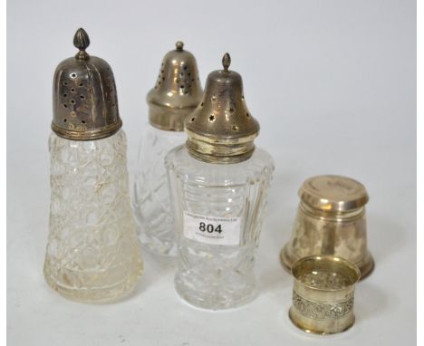 Two silver mounted cut glass sugar sifters, similar with a plated cover, Birmingham silver ink well and a silver napkin ring