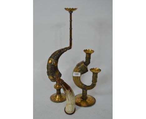 Two Middle Eastern brass mounted ram's horn candlesticks, 44cm high, together with a cattle horn powder flask