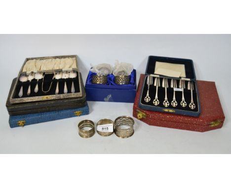 Three various silver napkin rings, set of four plated napkin rings, and a quantity of various cased plated flatware
