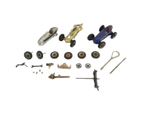 Schuco - a vintage German Schuco made tinplate clockwork model racing car together with a selection of additional spare parts