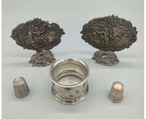 A Pair of French silver ornate Victorian scene card holders, Birmingham silver napkin ring and two silver thimbles. 