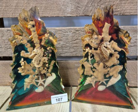 A Pair of vintage Lucite book ends having sea horse, coral and shells encased. [21cm high] 