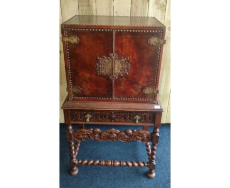 Antique 19th century oak and leather bound drinks cabinet. Brass lock and hinges, Brass stud trim, raised on four turned and 