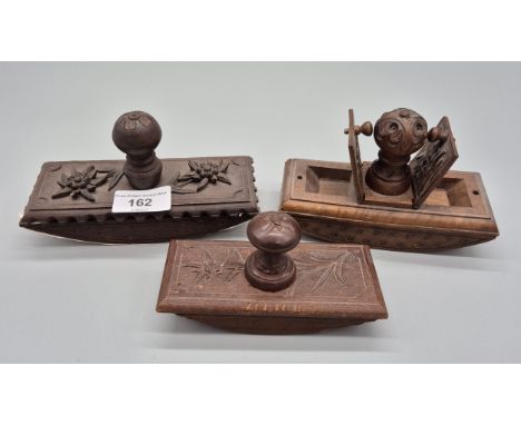A collection of three black forest carved inkwell blotters, one having hidden stamp holders. 