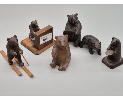 A collection six black forest carved bear figures; accordion player, skier figure, Piano player &amp; others [8cm] 