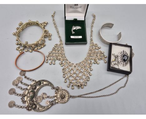 Various foreign belly dancer jewellery and pewter jewellery; Pewter Leaping trout pin, stag and Celtic brooch, together with 