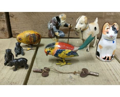 Selection of collectables; Antique Heyde Souvenir Nodder Almss Solicitor Nippes Figure, Three vintage Foreign tin plate toys-