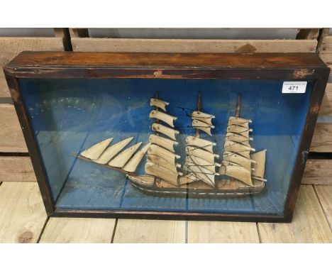 Antique raised relief galleon ship model within a glass and wood cabinet. [36x54cm] 