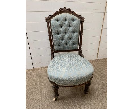 A Victorian framed nursing chair, upholstered button back on castors 