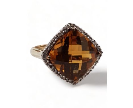 9 CARAT GOLD TOPAZ AND DIAMOND RING