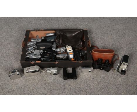 A box containing various compact digital and film cameras together with binoculars and opera glasses. The box comprises of, a