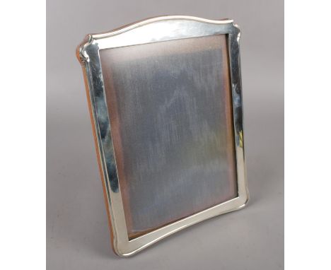 A George V silver mounted easel photo frame with oak back, assayed Birmingham 1916 by A &amp; K Zimmerman.  