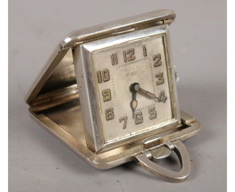 A continental silver cased art deco folding beside timepiece, Signed Novelti with black and blue enamel banding.  Timepiece i