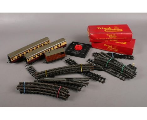 A collection of Tri-ang 00 gauge model railway, to include boxed track, battery connector, coaches etc.  
