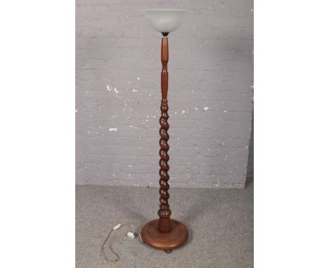 An oak turned floor lamp stand with circular base and glass up shade. Height 140cm.  Please note that this has not been PAT t