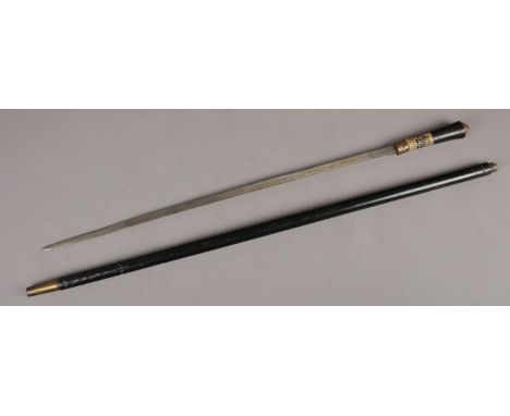 An ebonised sword stick with brass lion mask pommel, 92cm length.  