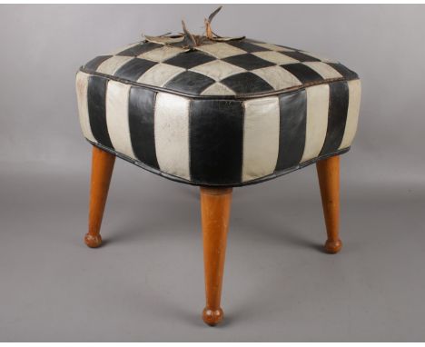 A Mid century Sherborne 'Tele-Pouffe', with beechwood legs and checker-board leather design. Height 35cm, width 42 cm.  Pleas