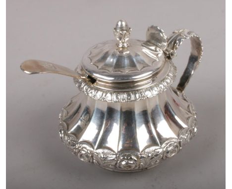 A George IV silver mustard pot with acorn finial and acanthus leaf handle and shell motif thumbpiece, assayed London 1822 by 