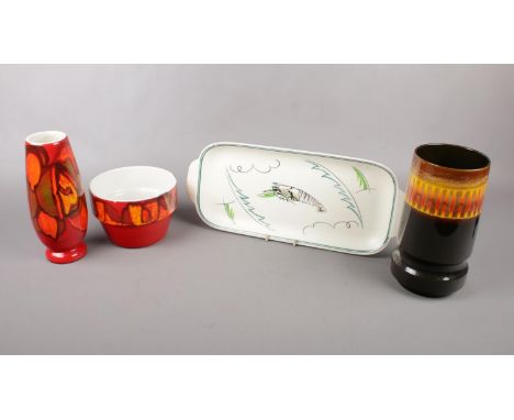 Four pieces of Poole Pottery, three Delphis ware comprising a shape 73 plant pot, a shape 15 vase and a shape 84 vase, togeth