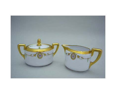 Porcelain Decorated, hand made, hand painted by Picard China featuring a Covered Sugar and Creamer. White ground, with gold e