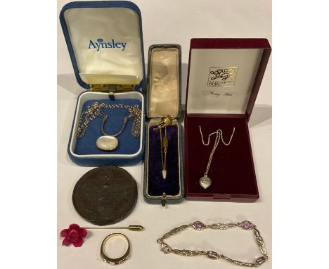 An unmarked three stone gold and diamond stick pin; a gold plated stick pin a silver and moonstone necklace; a silver and ame