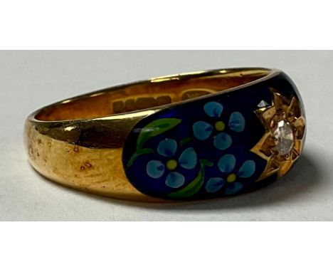 An 18ct gold diamond solitaire ring, the bezel set with painted floral cobalt blue enamel, size M, 6.2g 