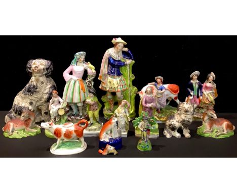 A Staffordshire pearlware figure, of a young gentleman, he stands, wearing a green cloak and fancy waistcoat, square base, 19