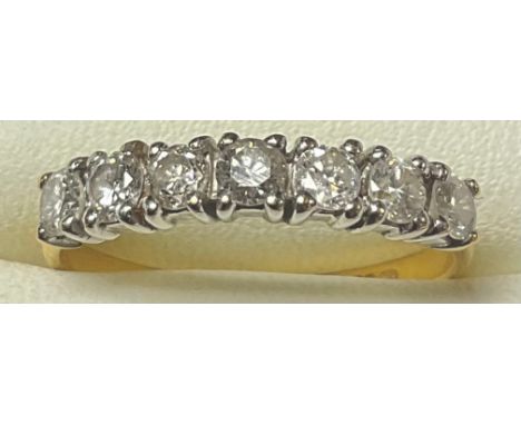 An 18ct gold seven stone diamond ring, size L, marked 750, 2g 